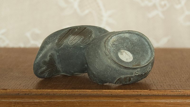 Single opened pewter duck box showing the interior storage compartment and lid.