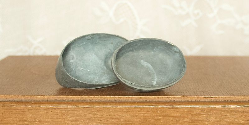 Single opened pewter duck box showing the interior storage compartment and lid.