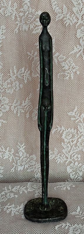 Staande figuur in stijl van Giacometti, ruw oppervlak met groene tonen in de dieptes